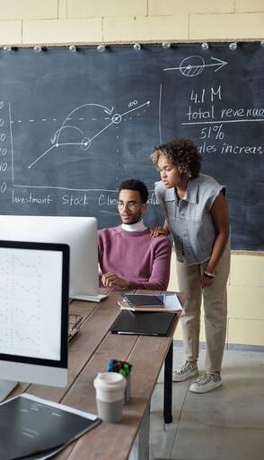 two-young-biracial-colleagues-looking-computer-screen-min.jpg