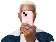 Person holding iPhone 15 in front of his face to conceal indentity