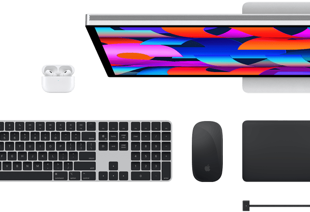 Top view of select Mac accessories: Studio Display, Magic Keyboard, Magic Mouse, Magic Trackpad, AirPods, and MagSafe charging cable